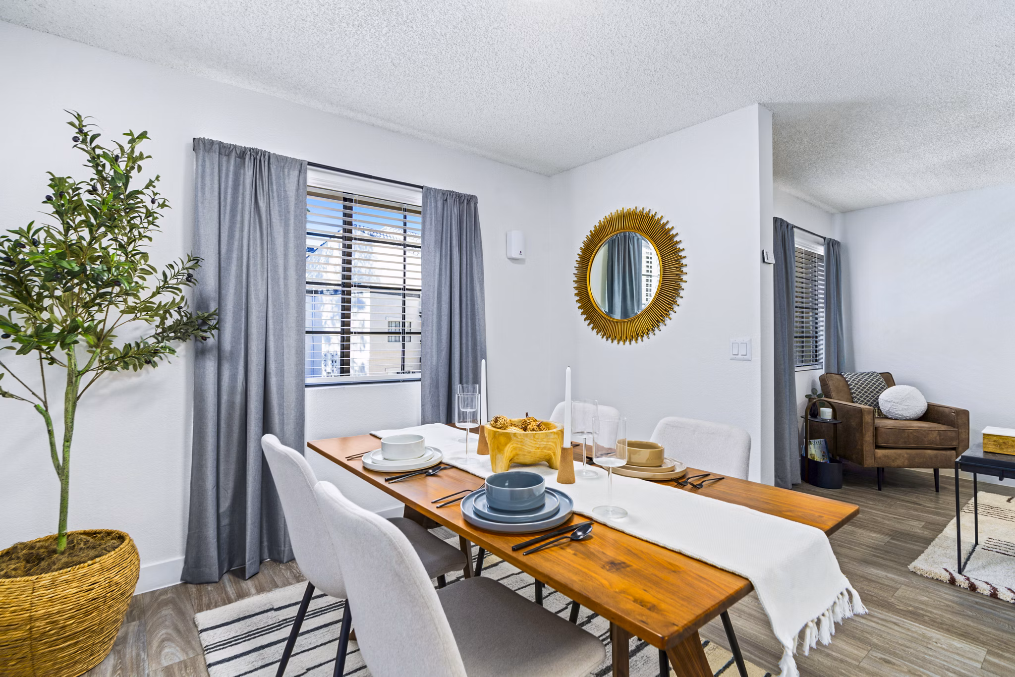 Dining area with modern furnishings at ENVii Apartments featuring sleek design and ample natural light