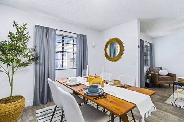 Dining area with modern furnishings at ENVii Apartments featuring sleek design and ample natural light