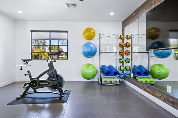 Yoga/spin studio with modern equipment at ENVii Apartments, promoting active lifestyle for residents
