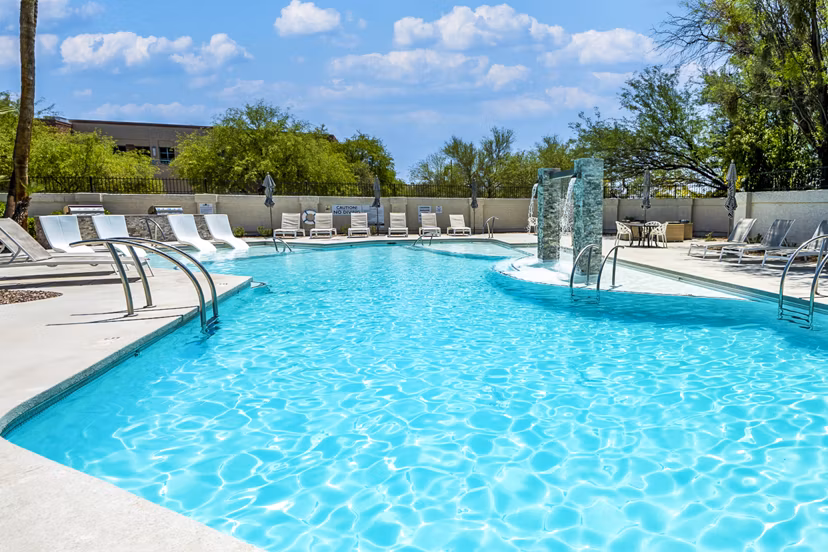 Expansive pool at ENVii Apartments with luxurious lounging areas for residents