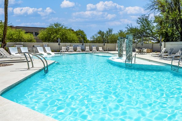 Expansive pool at ENVii Apartments with luxurious lounging areas for residents