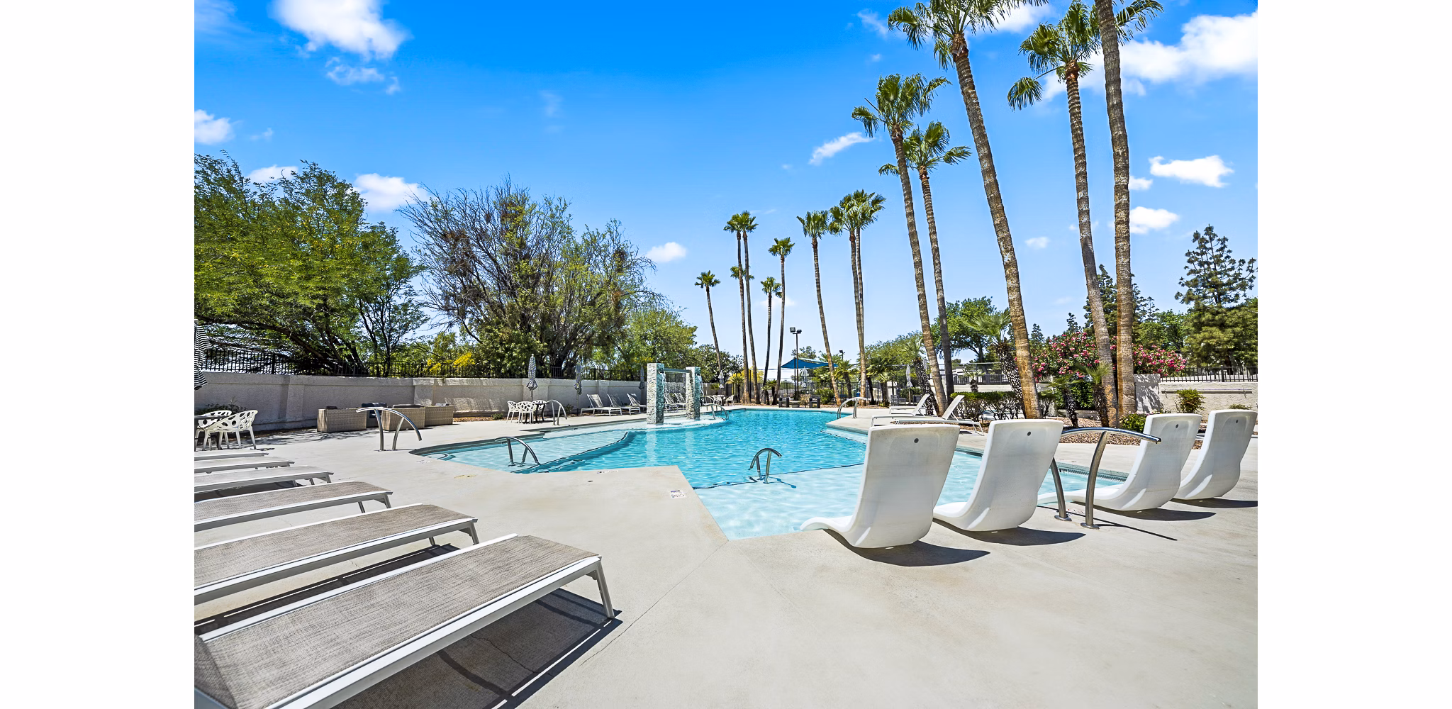 Chic rooftop pool with sun loungers at ENVii Apartments, offering luxury relaxation in a modern setting