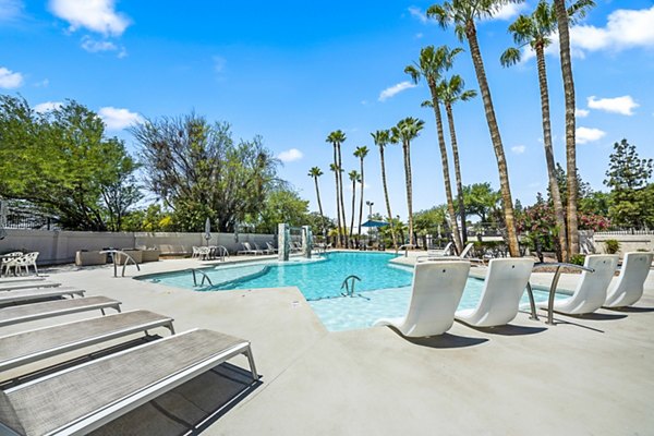 Chic rooftop pool with sun loungers at ENVii Apartments, offering luxury relaxation in a modern setting