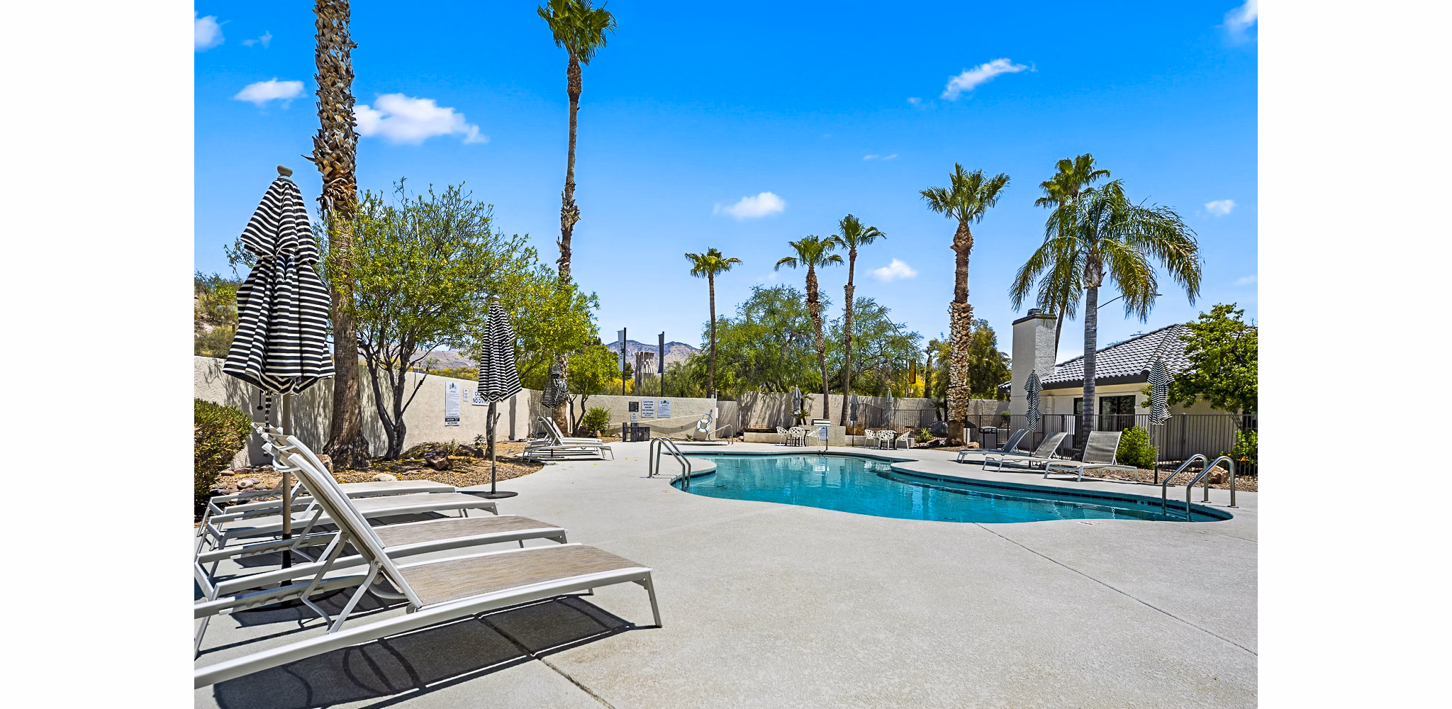 Relaxing poolside lounge area at ENVii Apartments