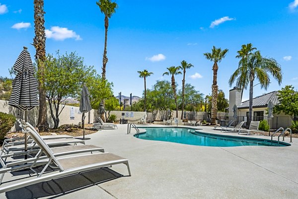 Relaxing poolside lounge area at ENVii Apartments