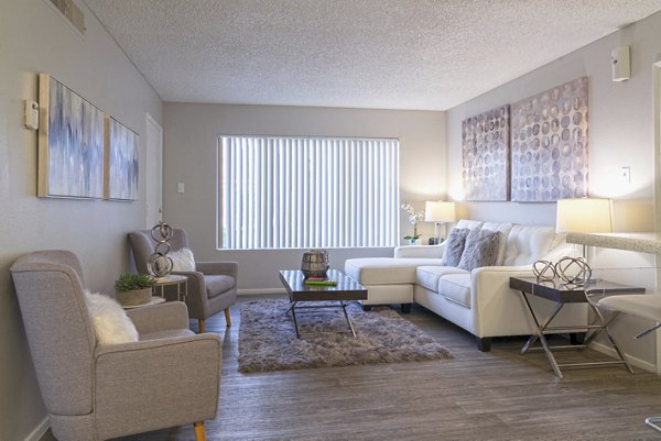 Stylish living room with modern furnishings and large windows at Westmount at Urban Trails Apartments
