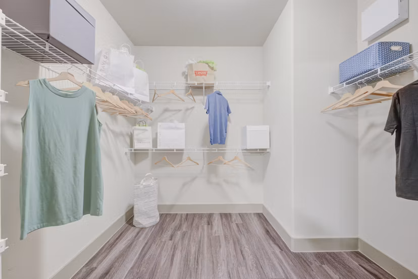 Spacious walk-in closet with built-in shelving in Lone Oak Apartments