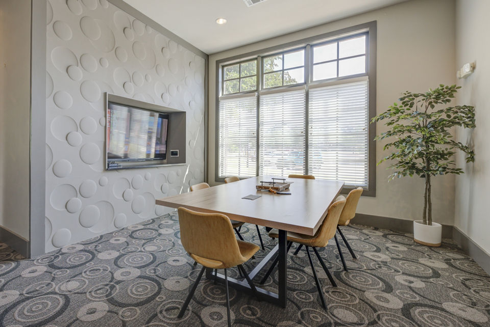 Modern meeting facility with a large conference table at Lone Oak Apartments, ideal for community gatherings and business meetings