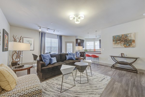 Spacious living room with modern decor at Lone Oak Apartments, featuring comfortable seating and ample natural light