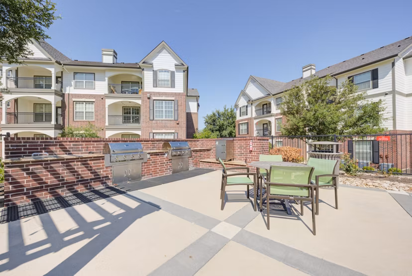 Outdoor grill area with modern seating at Lone Oak Apartments, offering luxury amenities for residents