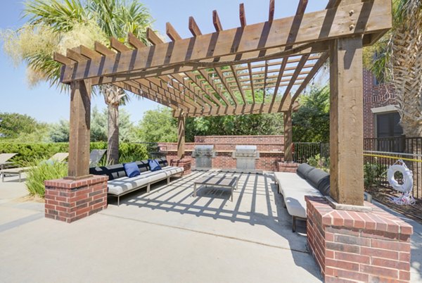 Outdoor grill area with modern seating at Lone Oak Apartments, perfect for gatherings and dining in the open air
