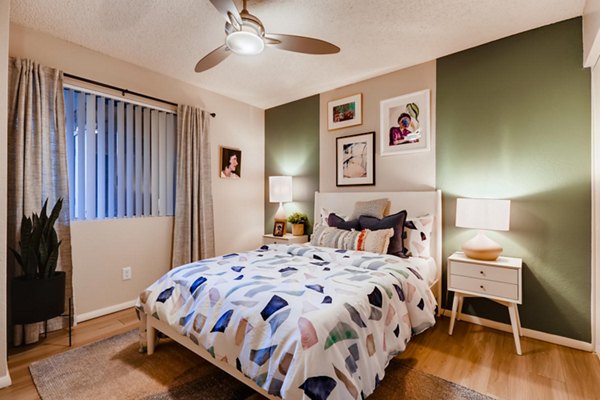 Cozy bedroom with modern decor at Espiral Apartments, featuring plush bedding and ambient lighting