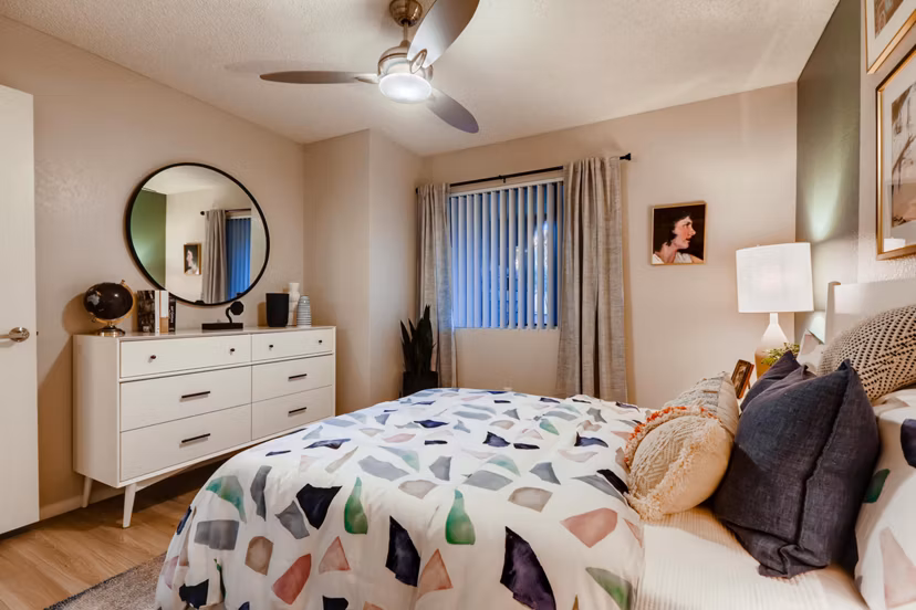 Bedroom featuring luxury bedding and modern decor at Espiral Apartments in San Diego