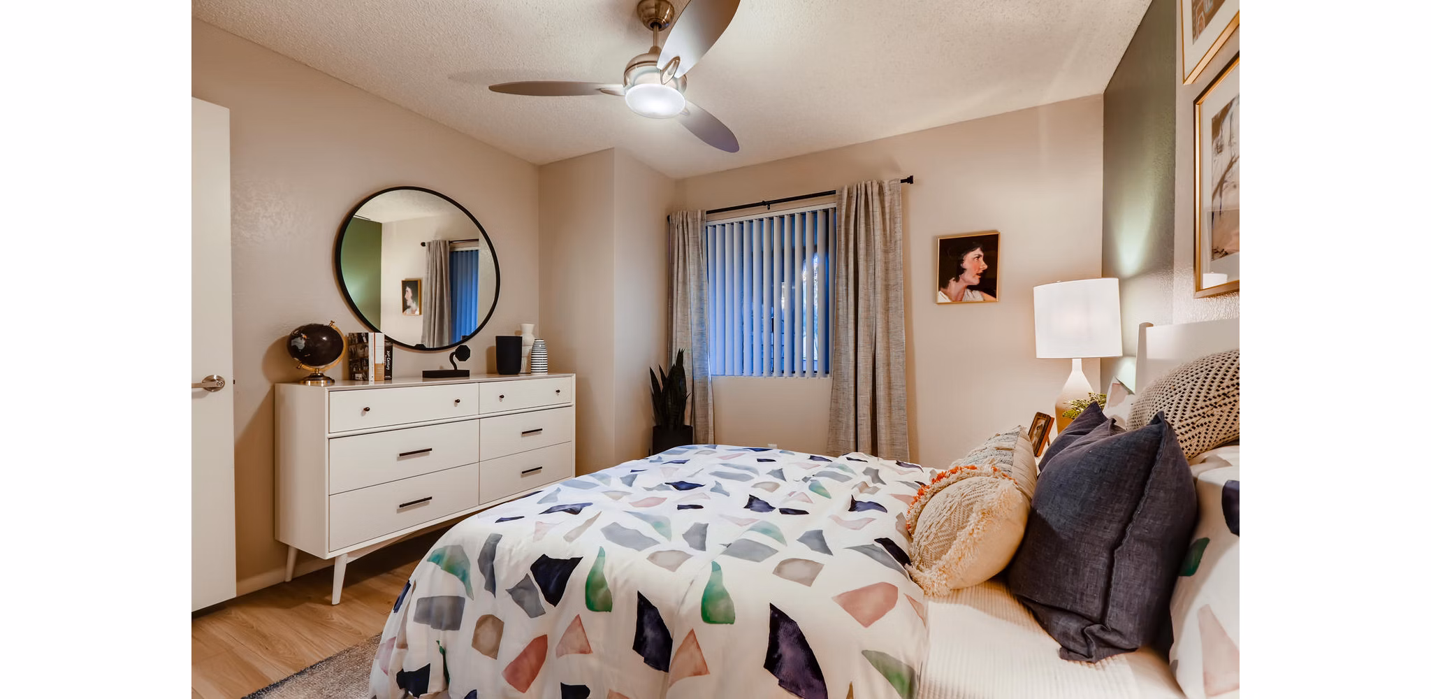 Bedroom featuring luxury bedding and modern decor at Espiral Apartments in San Diego
