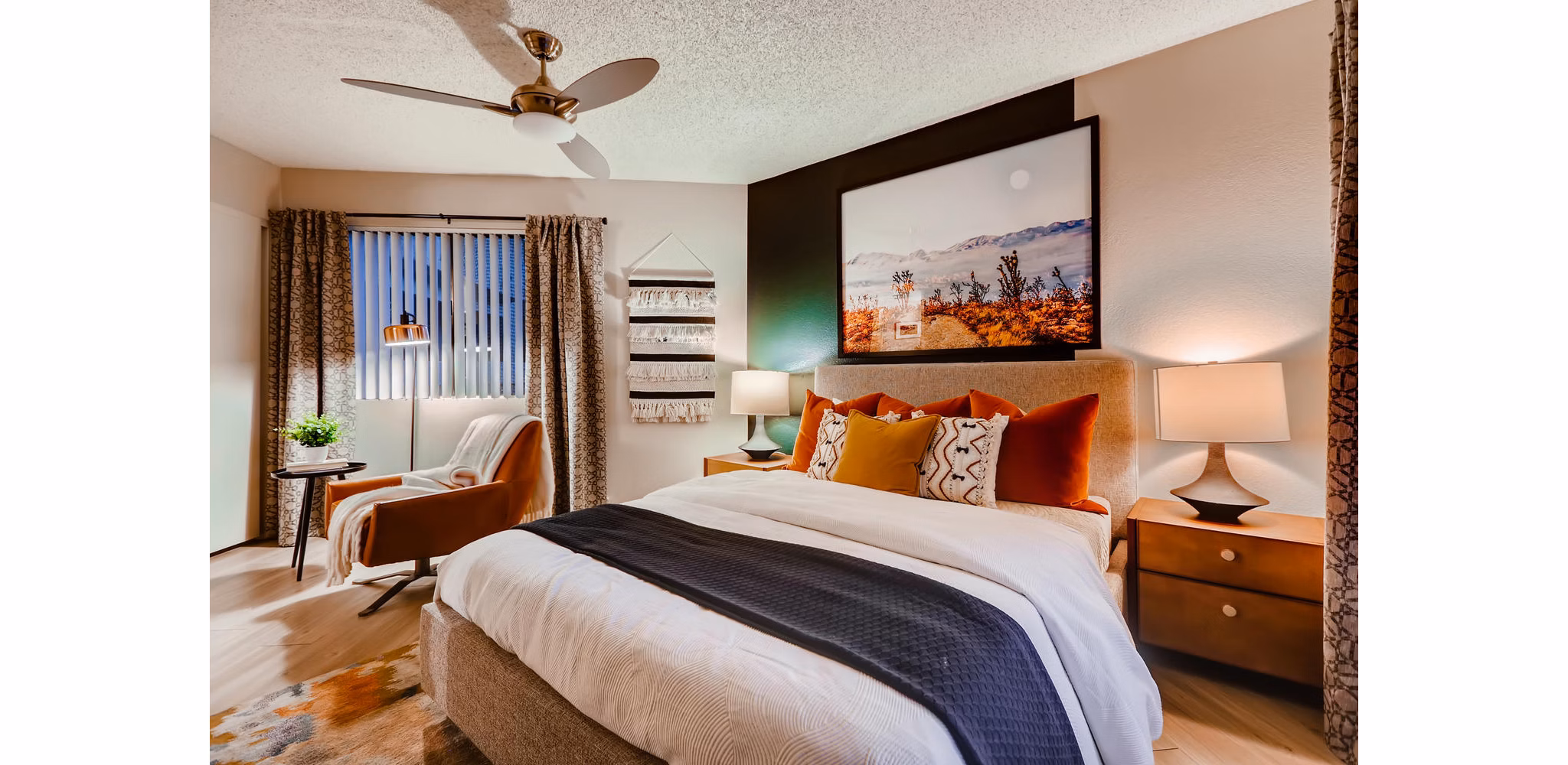 Modern bedroom with cozy decor and large windows in Espiral Apartments