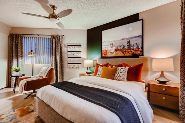 Modern bedroom with cozy decor and large windows in Espiral Apartments