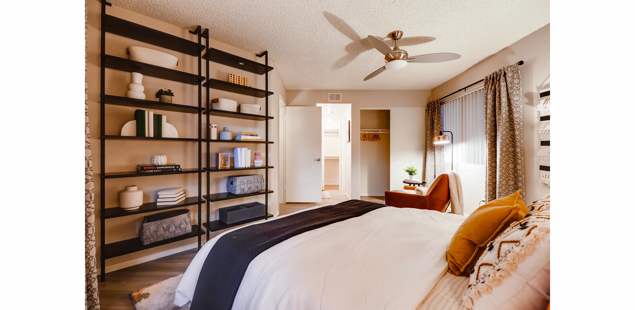 Bedroom with modern decor and large windows at Espiral Apartments, a Greystar luxury community