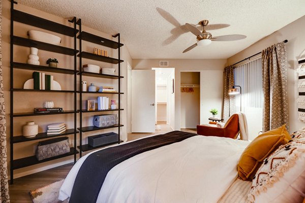 Bedroom with modern decor and large windows at Espiral Apartments, a Greystar luxury community