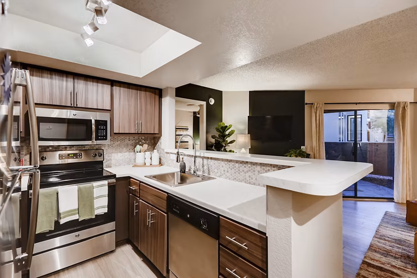Modern kitchen with stainless steel appliances and marble countertops at Espiral Apartments, luxury living in the heart of the city