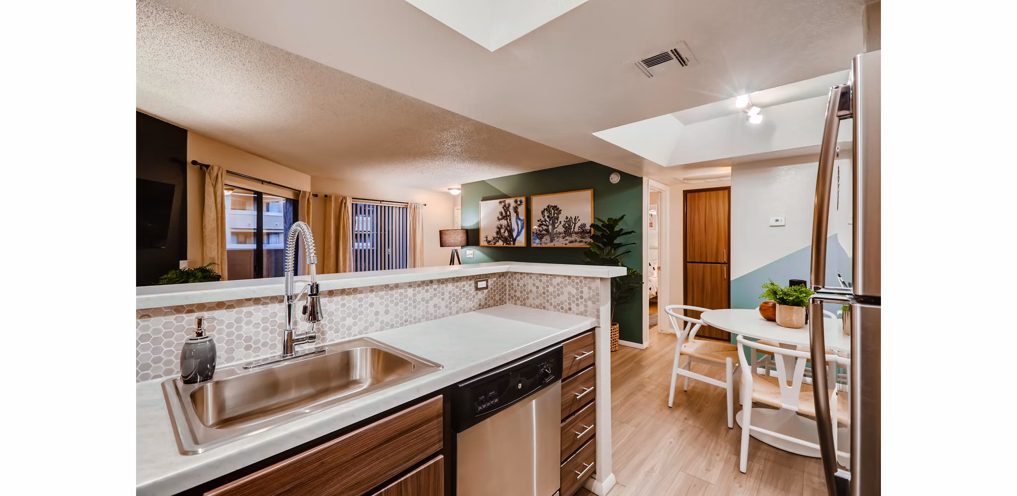 Contemporary kitchen with stainless steel appliances and granite countertops in Espiral Apartments
