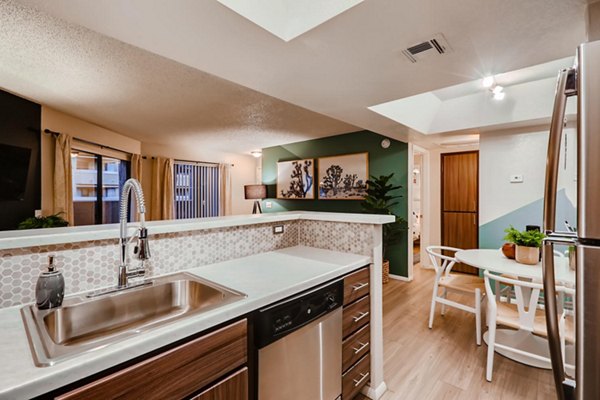 Contemporary kitchen with stainless steel appliances and granite countertops in Espiral Apartments