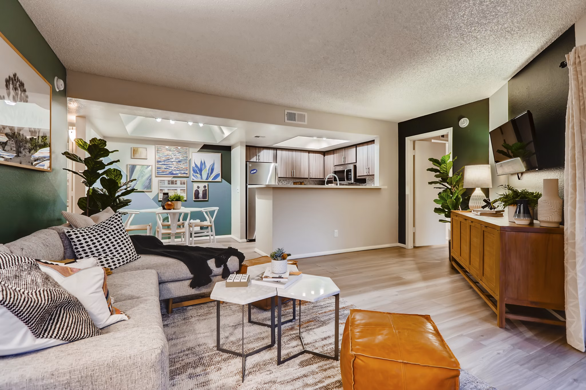 Spacious living room with modern decor and large windows in Espiral Apartments, luxury Greystar property