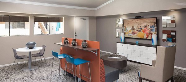 Clubhouse featuring modern design and ample seating at The Highlands at Grand Terrace Apartments