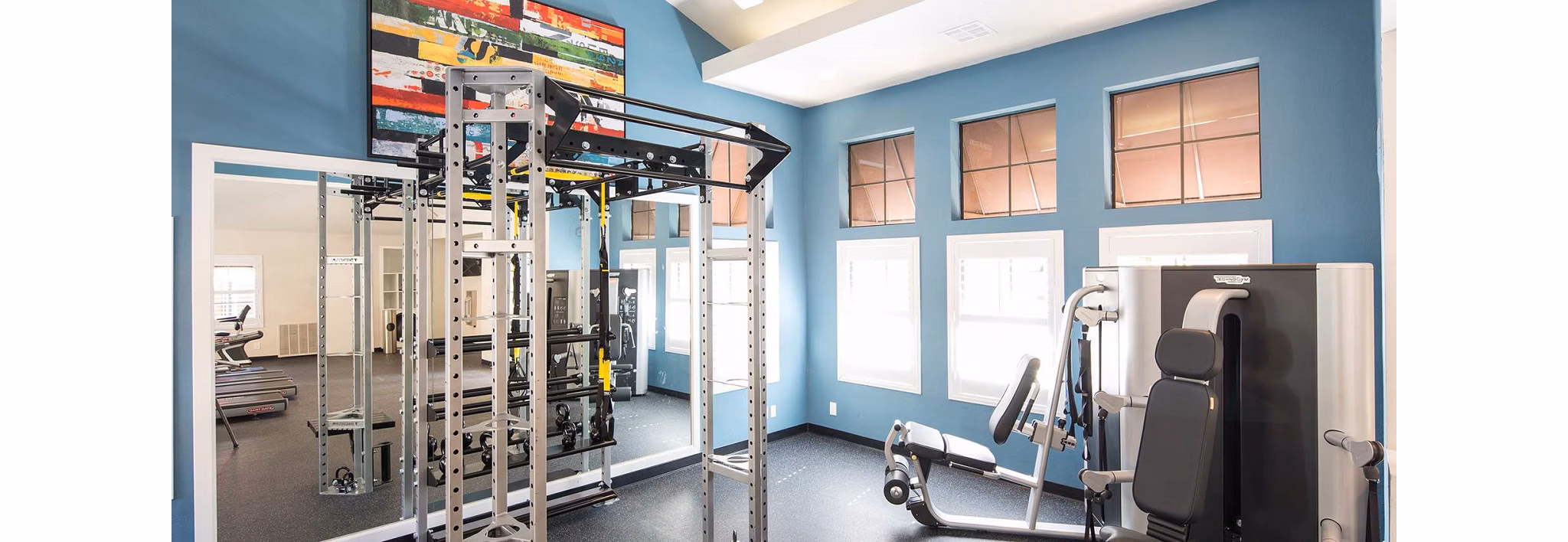 State-of-the-art fitness center at The Highlands at Grand Terrace Apartments, featuring modern exercise equipment for residents