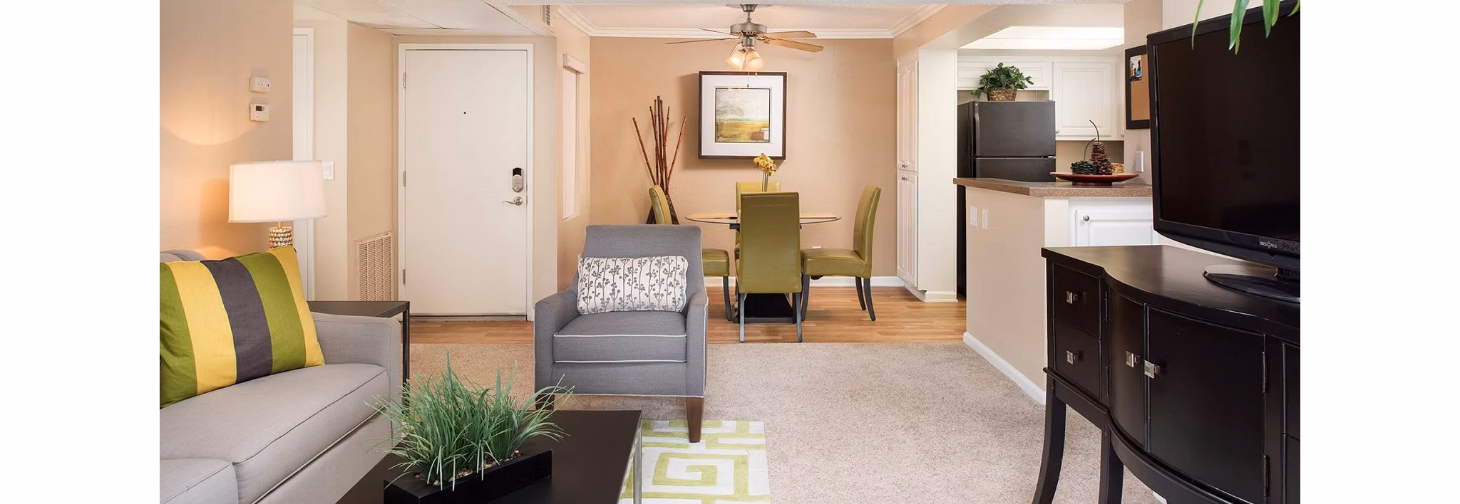 Spacious living room with modern furnishings at The Highlands at Grand Terrace Apartments