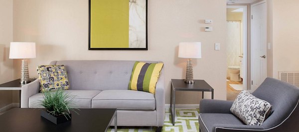 Spacious living room with elegant furnishings at The Highlands at Grand Terrace Apartments