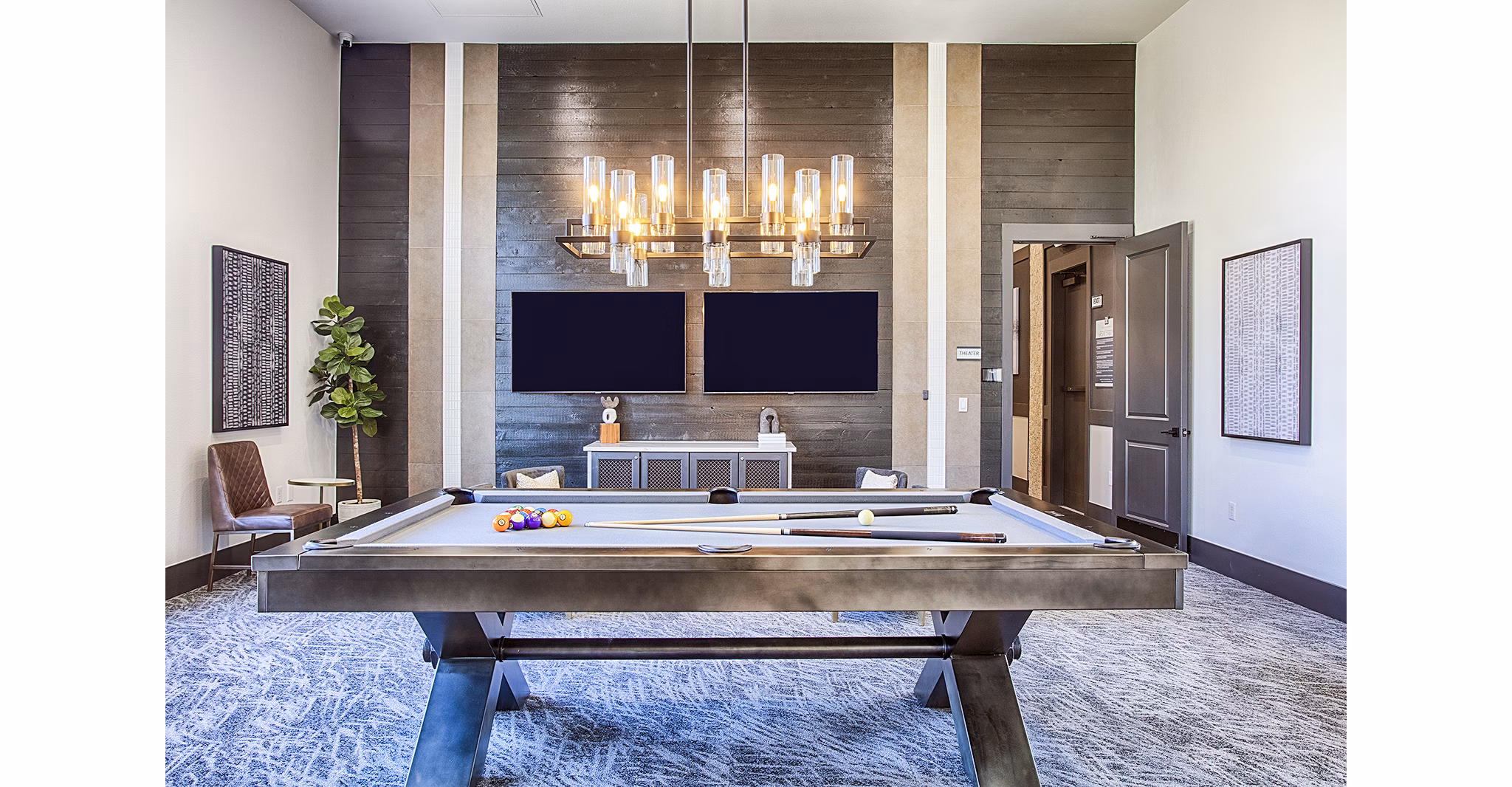 Game room with pool table and lounge seating at Rockrimmon Apartments clubhouse, ideal for socializing in a luxury setting
