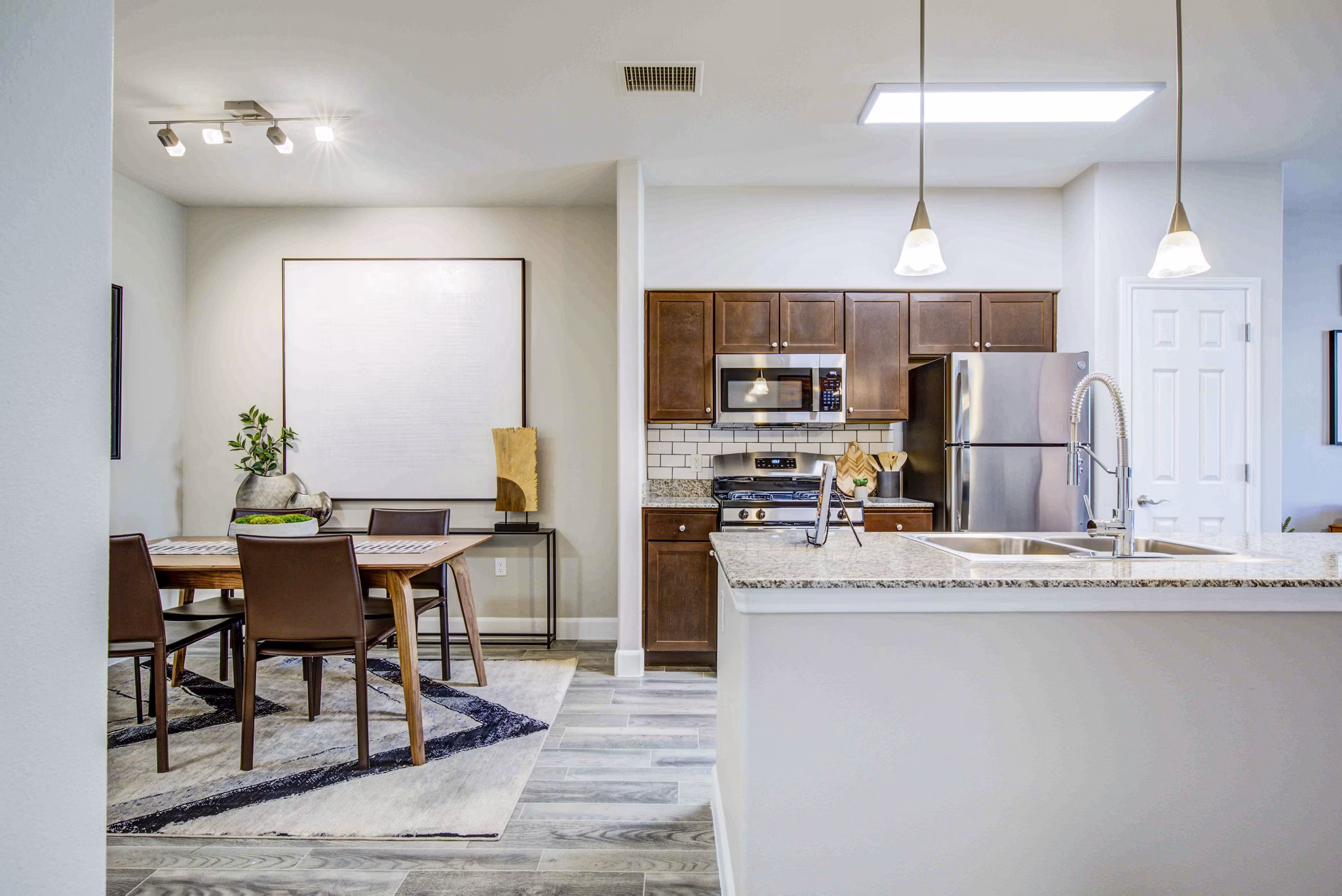 Modern kitchen with stainless steel appliances at Rockrimmon Apartments