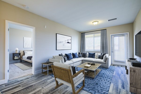 Spacious living room with modern decor at Rockrimmon Apartments, showcasing luxury design and comfort