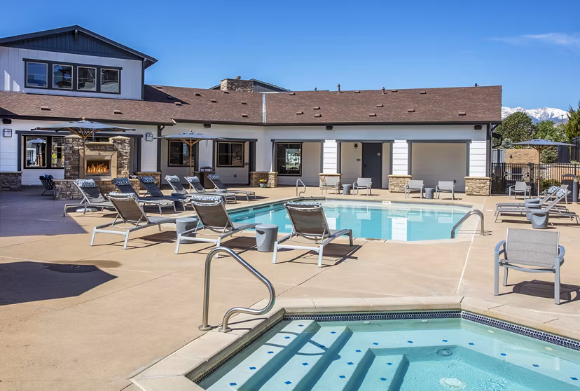 Outdoor pool with comfortable lounge seating at Rockrimmon Apartments