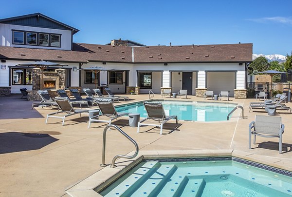 Outdoor pool with comfortable lounge seating at Rockrimmon Apartments