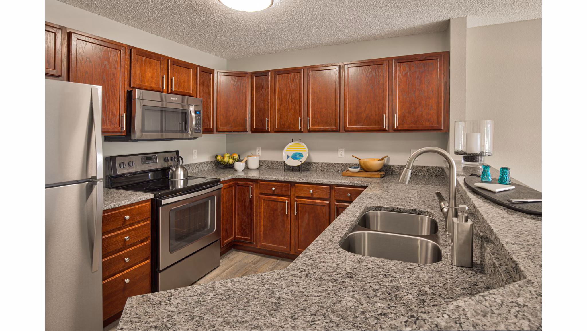 Modern kitchen featuring stainless steel appliances in Avana Addison Apartments, luxury living at Greystar communities