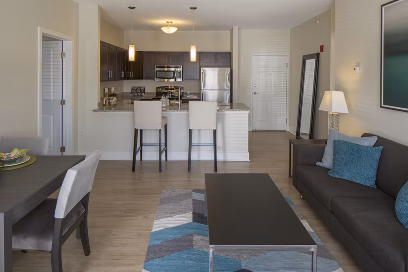 Modern living room featuring sleek furnishings and natural light at Avana Addison Apartments
