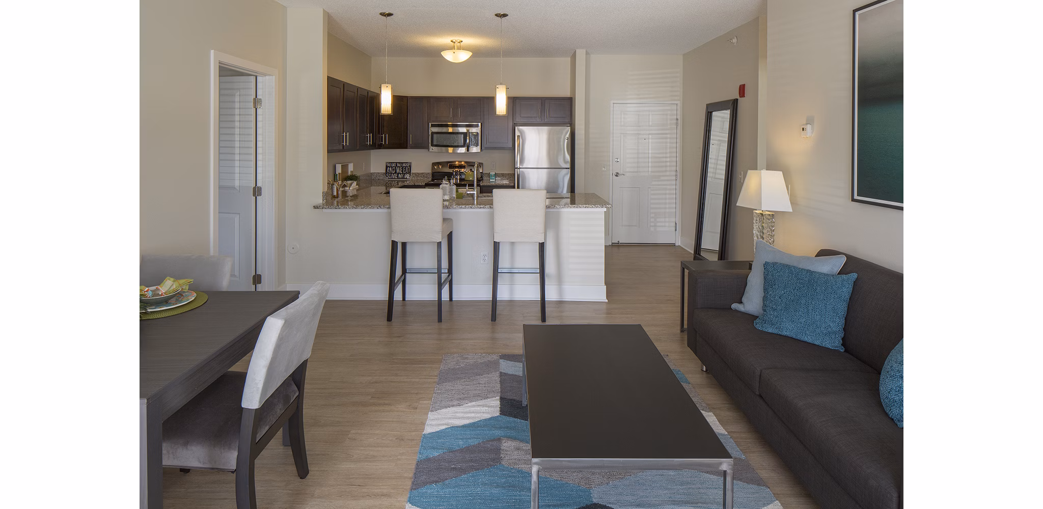 Modern living room featuring sleek furnishings and natural light at Avana Addison Apartments