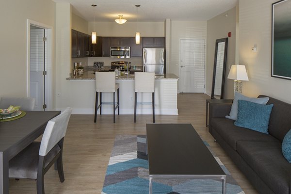 Modern living room featuring sleek furnishings and natural light at Avana Addison Apartments