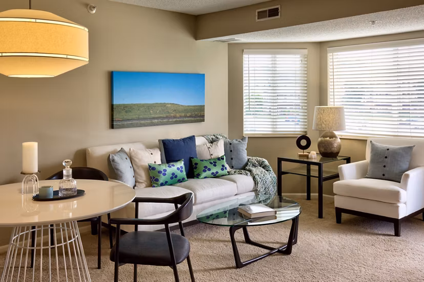 Spacious living room with modern decor and natural light at Avana Addison Apartments
