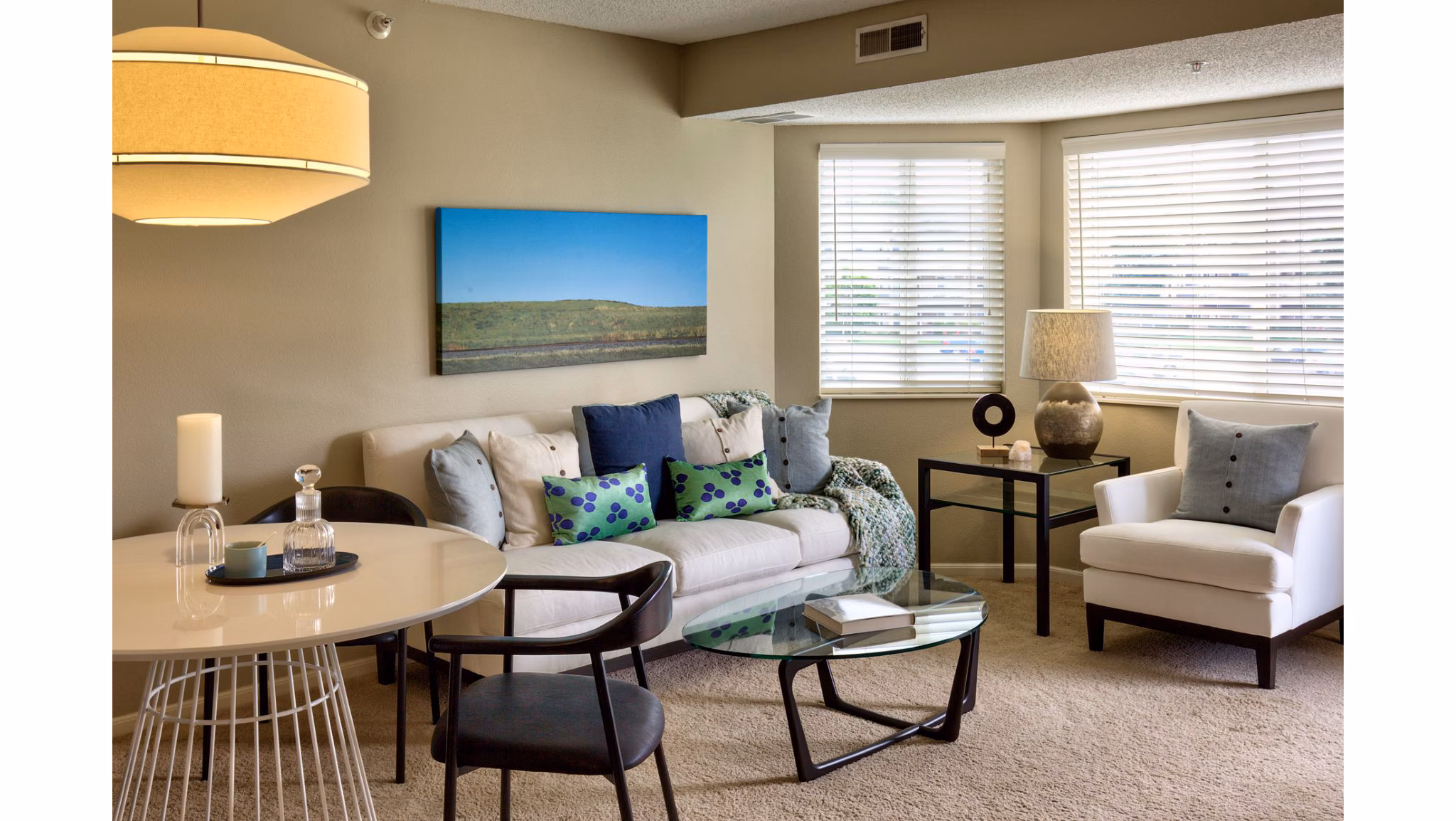 Spacious living room with modern decor and natural light at Avana Addison Apartments