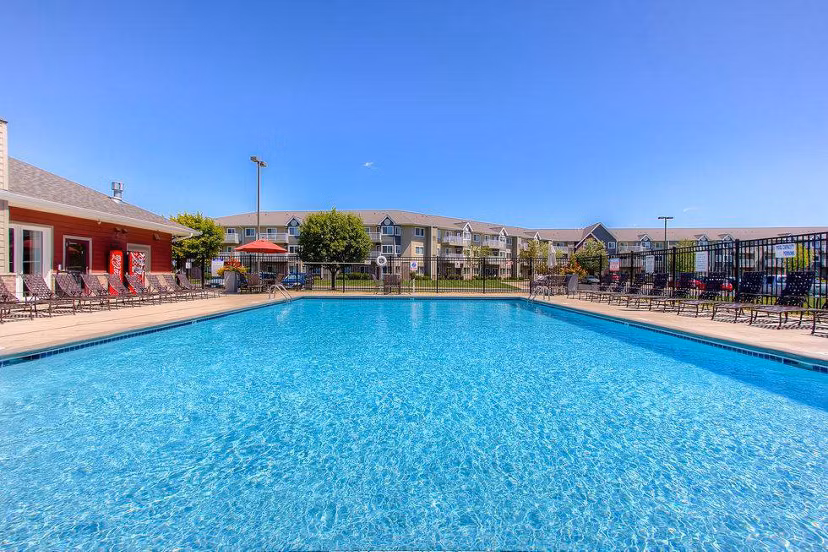Rooftop pool with lounge chairs at Avana Addison Apartments