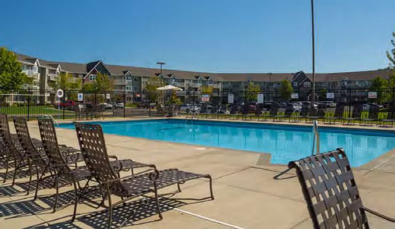 Resort-style pool with lush landscaping at Avana Addison Apartments in Dallas, offering a luxury relaxation experience for residents