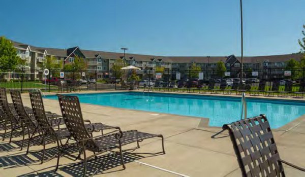 Resort-style pool with lush landscaping at Avana Addison Apartments in Dallas, offering a luxury relaxation experience for residents