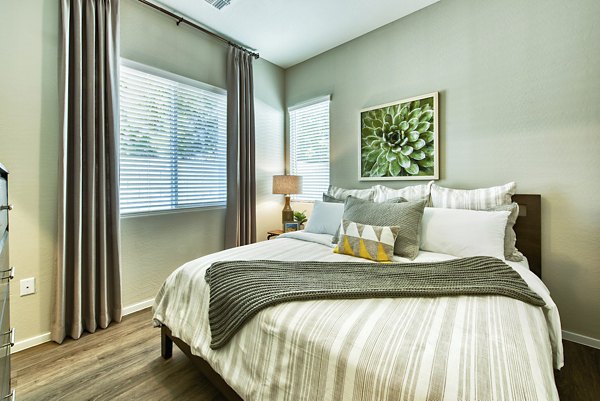 Comfortable bedroom with stylish decor in Abode at Litchfield Park Apartments