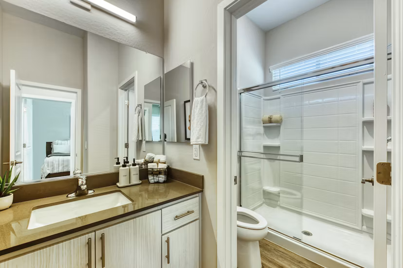 Bathroom with sleek fixtures and marble countertops in Abode at Litchfield Park Apartments