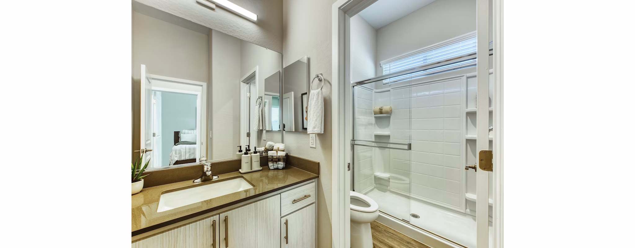 Bathroom with sleek fixtures and marble countertops in Abode at Litchfield Park Apartments