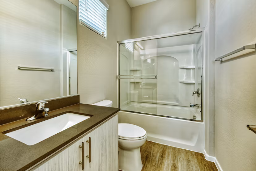 Modern bathroom with sleek fixtures and ample lighting at Abode at Litchfield Park Apartments