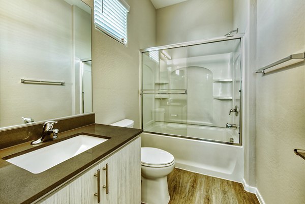 Modern bathroom with sleek fixtures and ample lighting at Abode at Litchfield Park Apartments