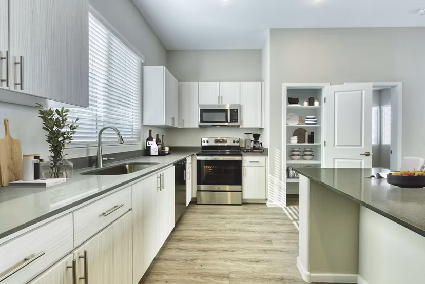 Modern kitchen with stainless steel appliances at Abode at Litchfield Park Apartments